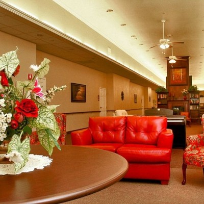 Long common area with red couch and chairs